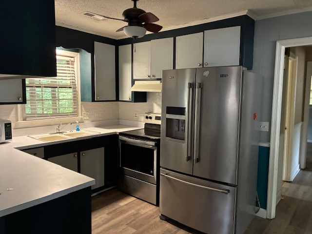 Kitchen with stainless refrigerator
