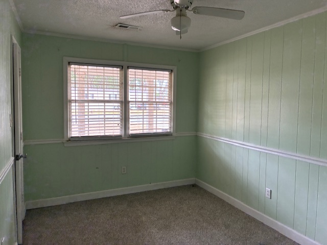 Bedroom with green wall paneling