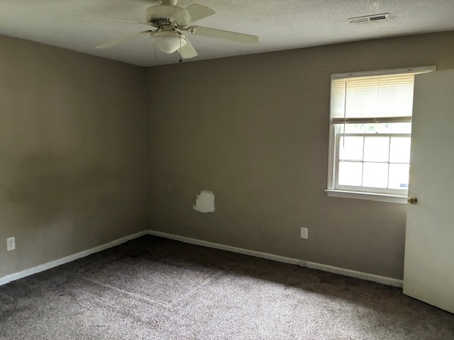 Bedroom with carpet and window