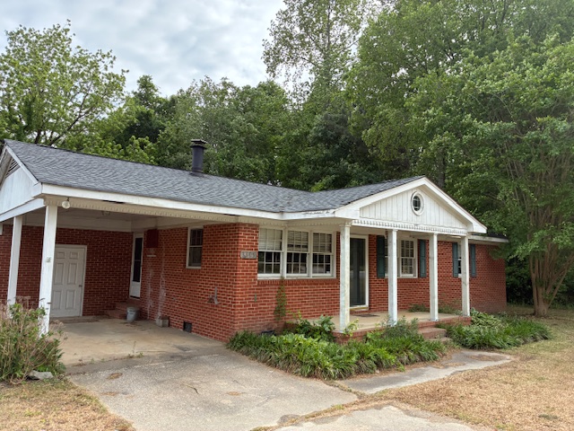 Front exterior with carport