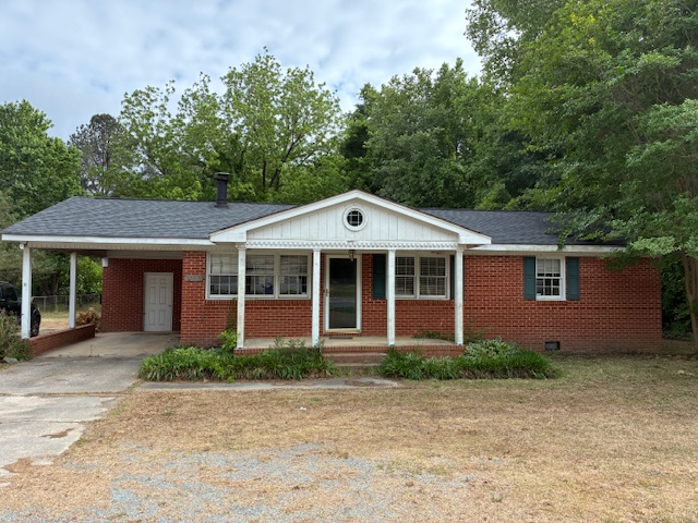 Front exterior of the brick ranch home at 3395 Hwy 210