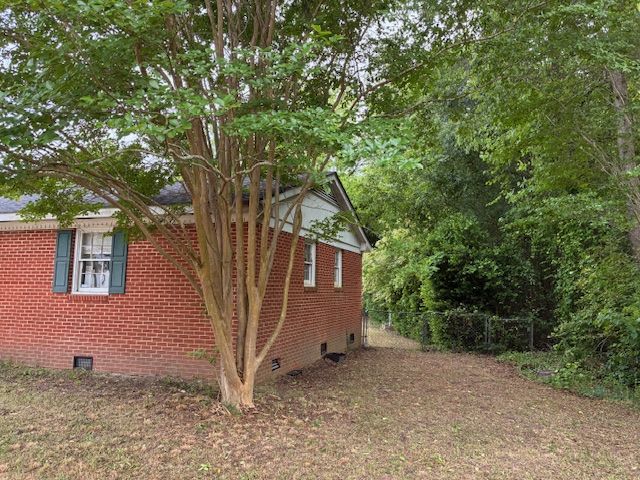 Side exterior with mature tree