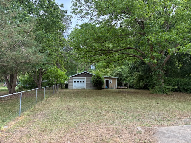 Fenced backyard with detached garage